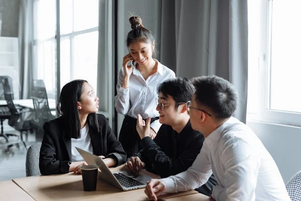 Group of coworkers collaborating in an office meeting.